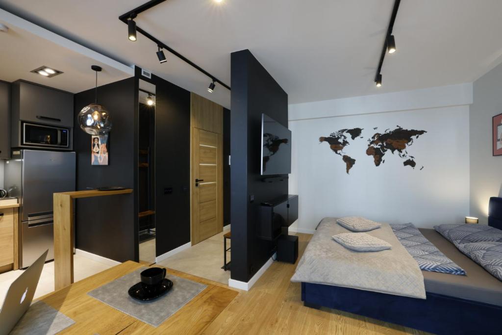 a bedroom with a bed with a world map on the wall at Narutowicza Center in Łódź