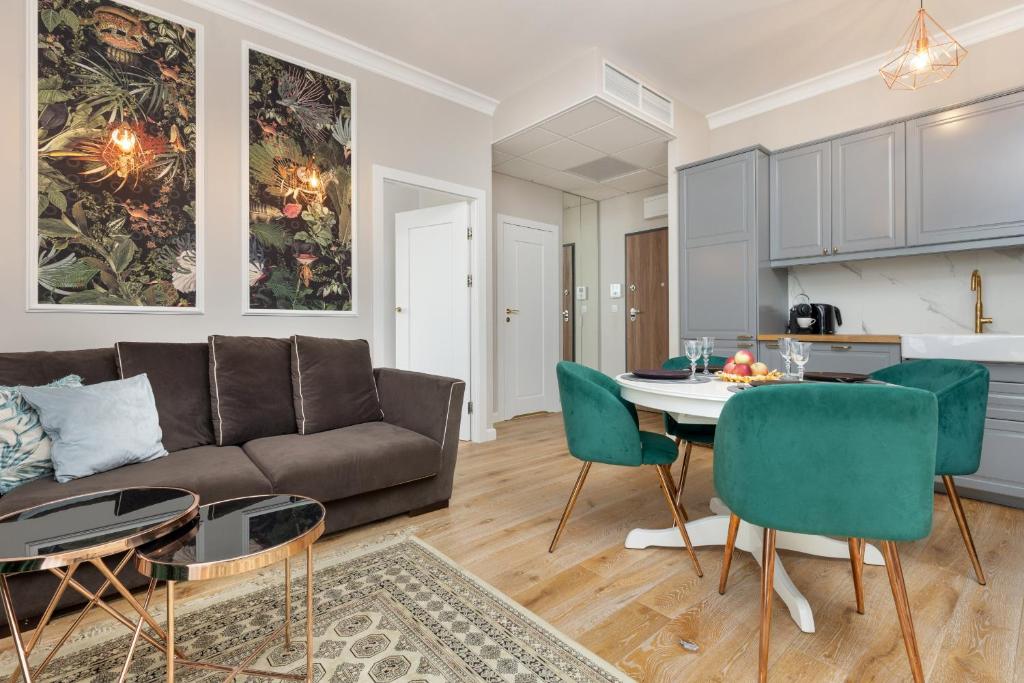 a living room with a couch and a table at Wola Beautiful Pet-Friendly Apartment by Renters in Warsaw