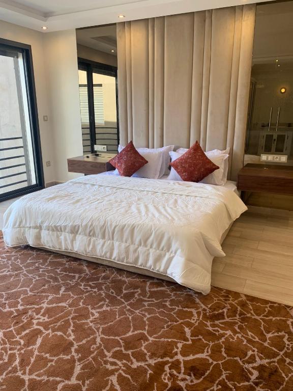 a large white bed in a room with a window at Incantevole villa Safi Sidi Bouzid near beach in Safi