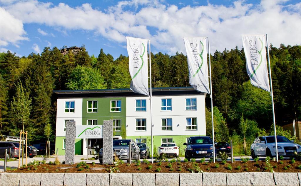 a building with two flags in front of it at Hotel Eyberg in Dahn