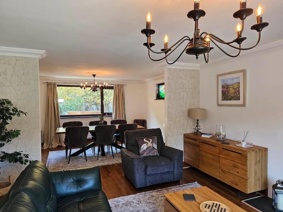 a living room with a couch and a dining room at Riverside Retreat in Llandysul
