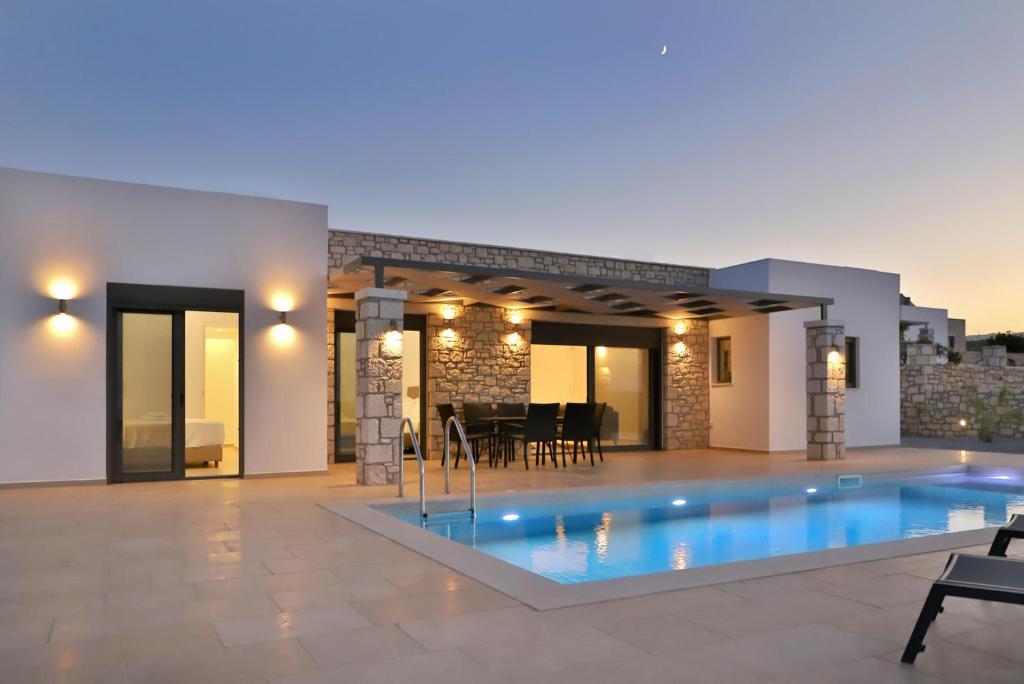 a swimming pool in the middle of a house at Villa Tropicana, luxury villa with pool by Sternes Properties in Sitia