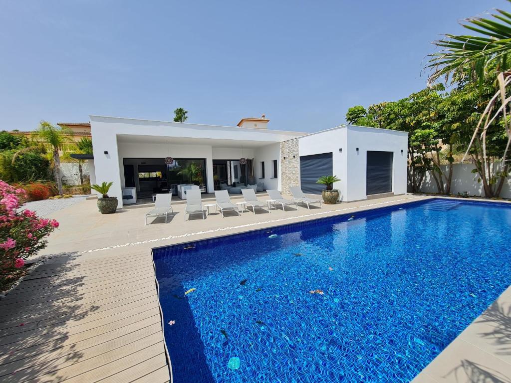 a swimming pool in front of a house at Moraira B5 in Moraira