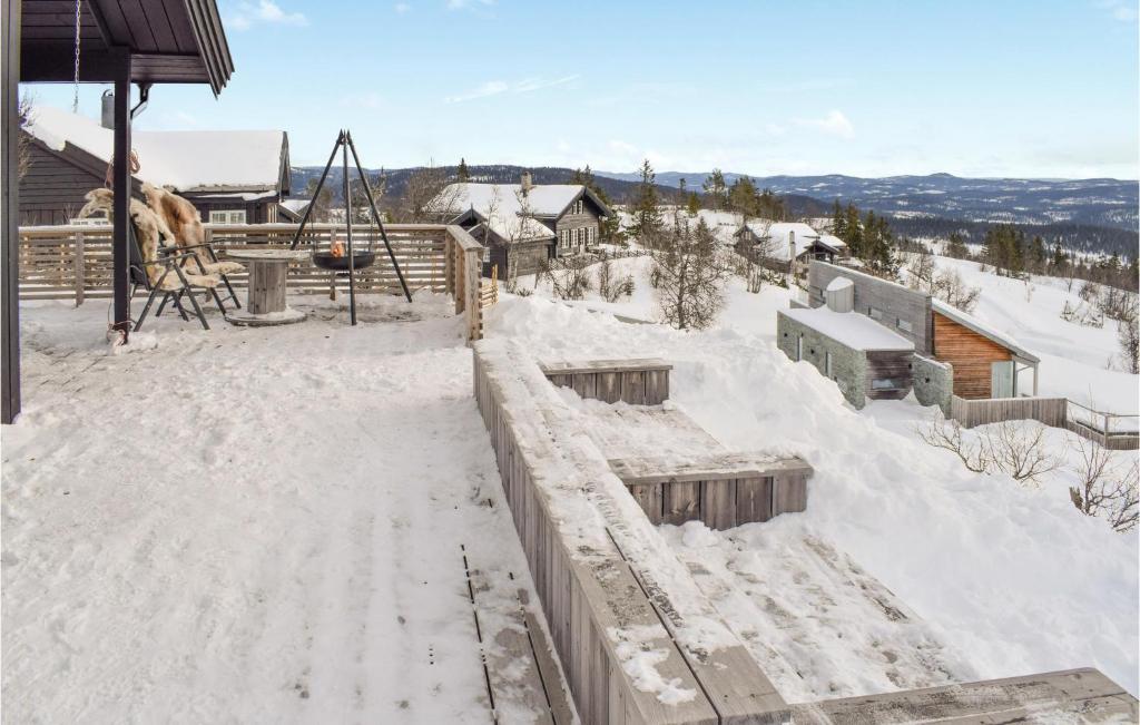 a playground covered in snow next to a house at Stunning Home In Etnedal With Wifi And 4 Bedrooms in Etnedal