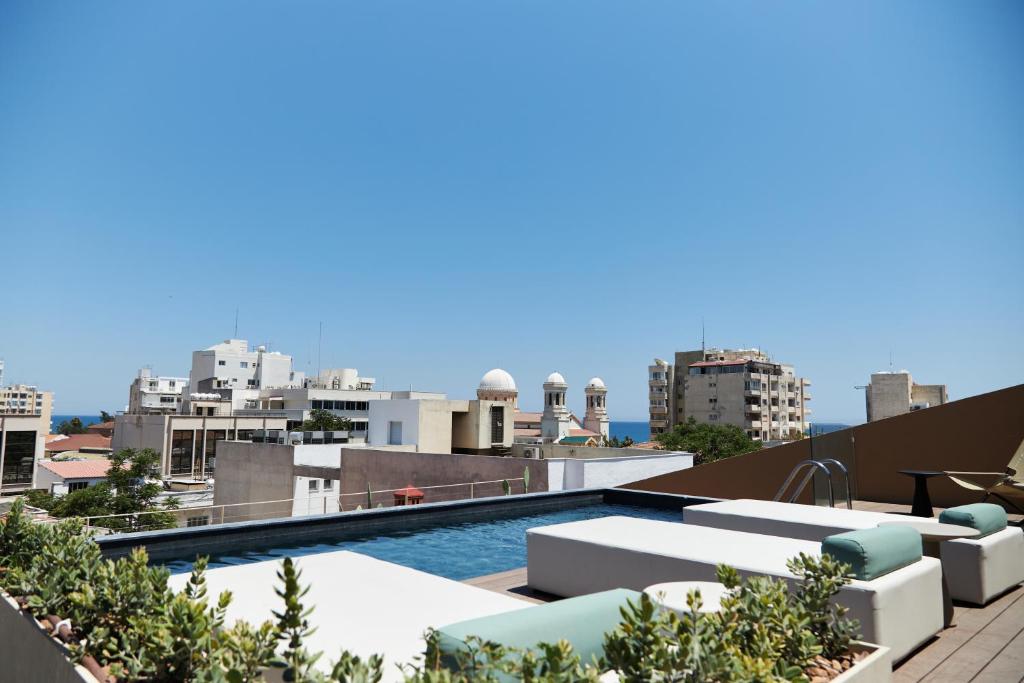 a swimming pool on the roof of a building at Alinea Primo Historic Center in Limassol