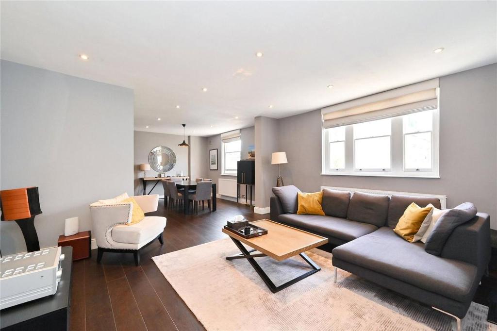ein Wohnzimmer mit einem Sofa und einem Tisch in der Unterkunft Large 3 Bedroom Covent Garden Apartment in London