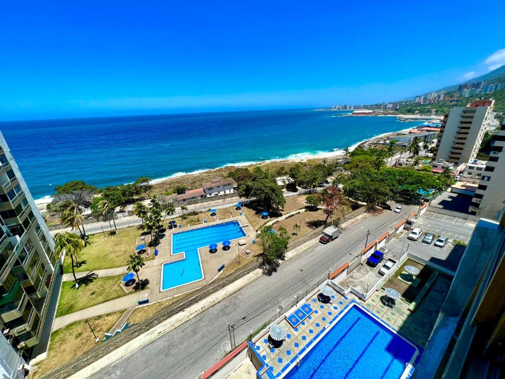 an aerial view of a beach with two pools and the ocean at Casa de la Playa in Macuto