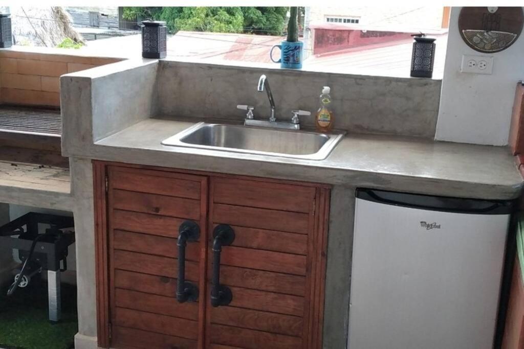 a kitchen with a sink and a dishwasher at 2 Bed Cozy Townhouse & Terrace Pool in La Ceiba