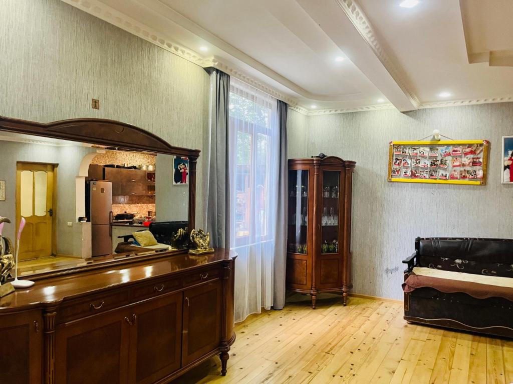 a room with a dresser and a mirror on the wall at Guesthouse Taso in Naki