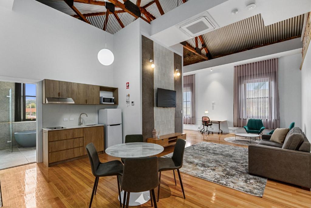 a kitchen and living room with a table and chairs at Costello Hotels Port Augusta in Port Augusta