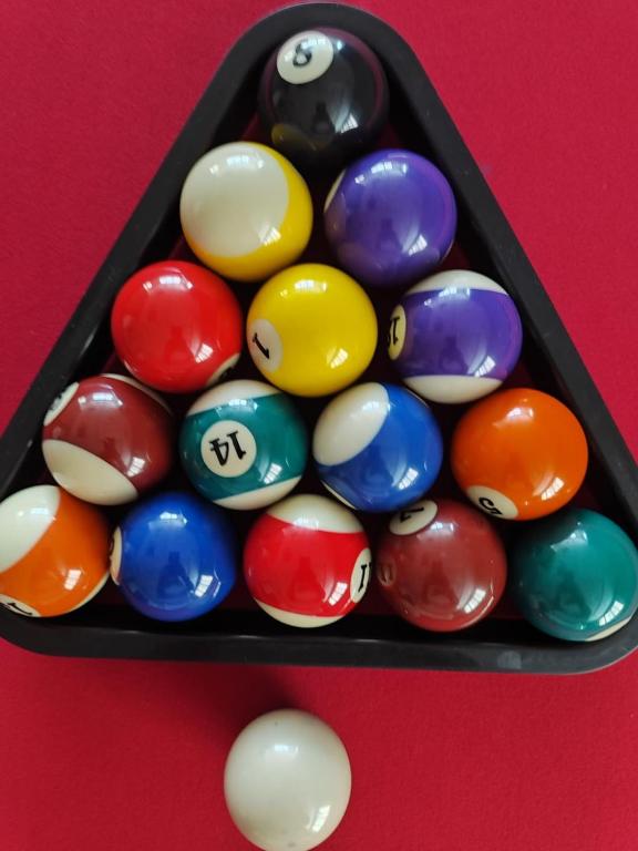 a group of pool balls on a red table at Al Raya Hotel Apartments in Dubai