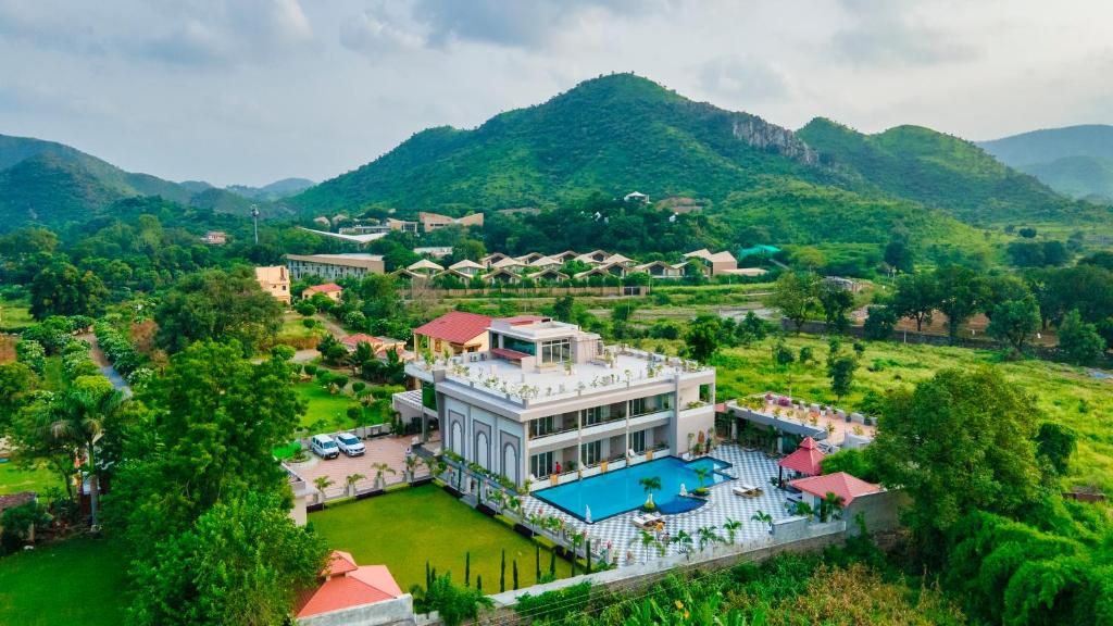 an aerial view of a large house with a swimming pool at Mountain Creek Villa Udaipur in Udaipur