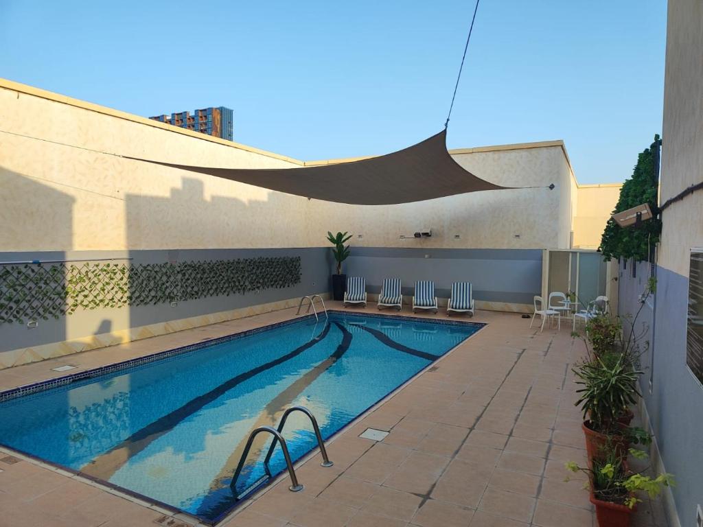 a swimming pool on the side of a building at Al Raya Hotel Apartments in Dubai