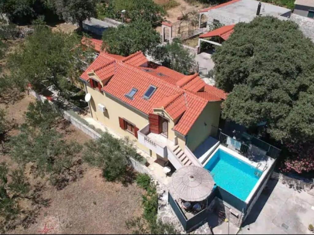 an aerial view of a house with a swimming pool at Charming holiday home with private pool and covered terrace in Škrip