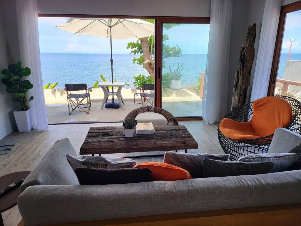 a living room with a couch and a table and the ocean at Royal Seascape in San Juan