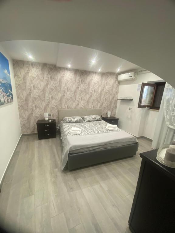 a bedroom with a large bed in a room at DALY home intero appartamento in Mugnano di Napoli