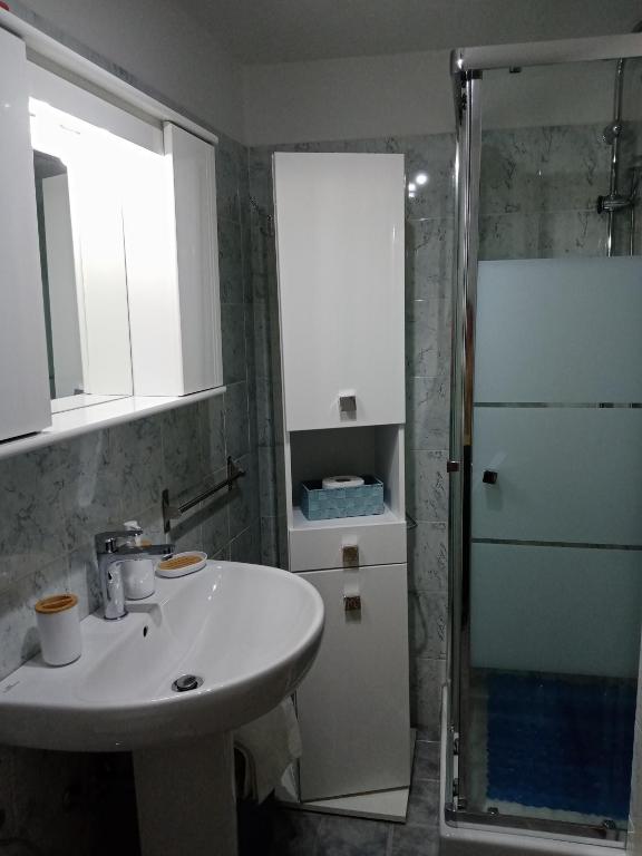 un bagno con lavandino e doccia di La Dimora di Pietra a Gubbio