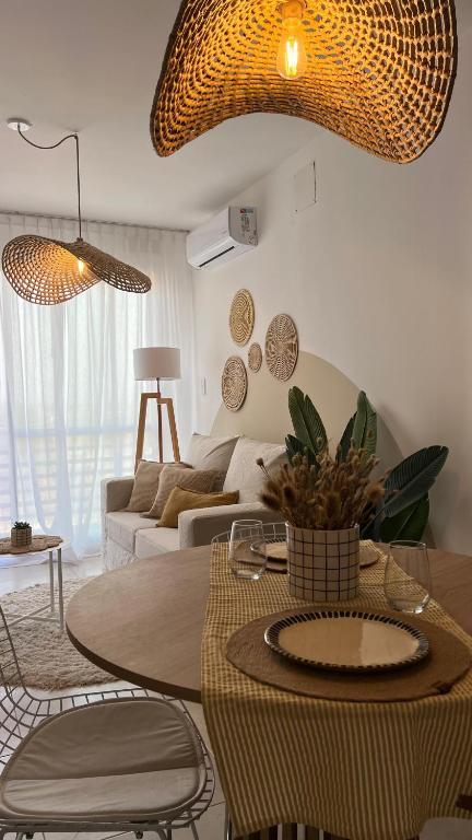 a living room with a table and a couch at Departamento complejo Vita in Concepción del Uruguay