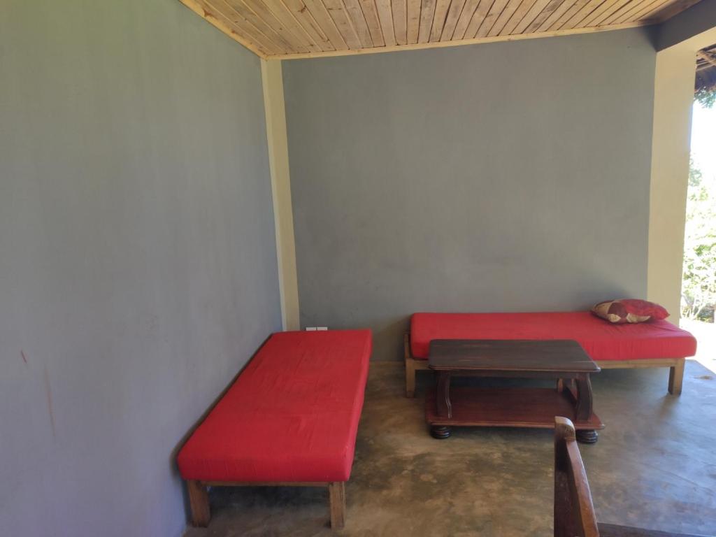a room with two red benches in a room at Villa Métisse in Nosy Be