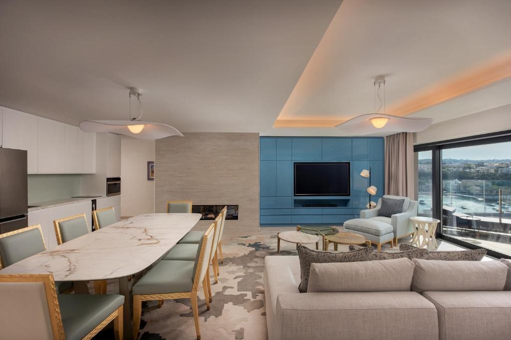 a kitchen and living room with a table and a couch at The Westin Dragonara Resort, Malta in St. Julianʼs