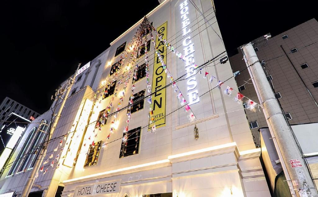 a building with a lit up sign on the side of it at Hotel Cheese Ulsan Samsan in Ulsan