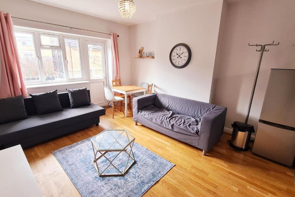 a living room with a couch and a table at 5 SLEEPER CLOSE TO OLD STREET/ SHOREDITCH in London