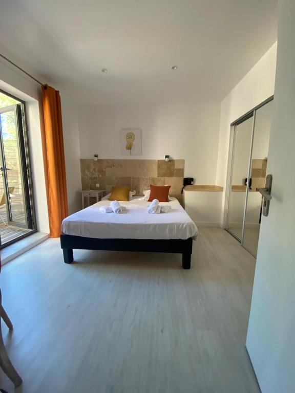 a bedroom with a bed and a large window at Le Belvedere in Vallon-Pont-dʼArc