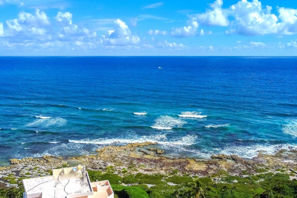 an aerial view of the ocean with waves at Santamar by Tao Beach Condos with Pool & Walk to Ocean in Akumal