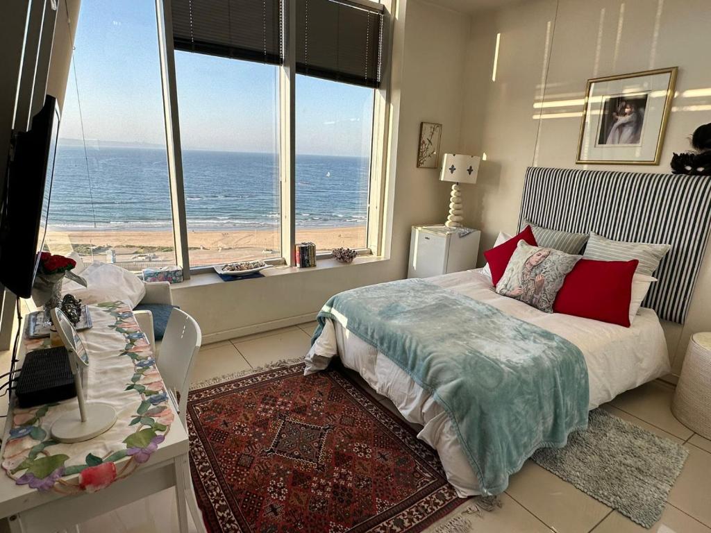 a bedroom with a bed and a view of the ocean at DNA Dream Home in Durban