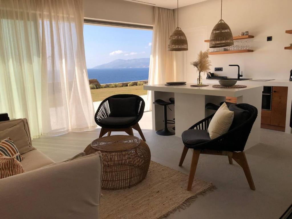 a living room with a view of the ocean at On The Rocks Villas Ios in Ios Chora