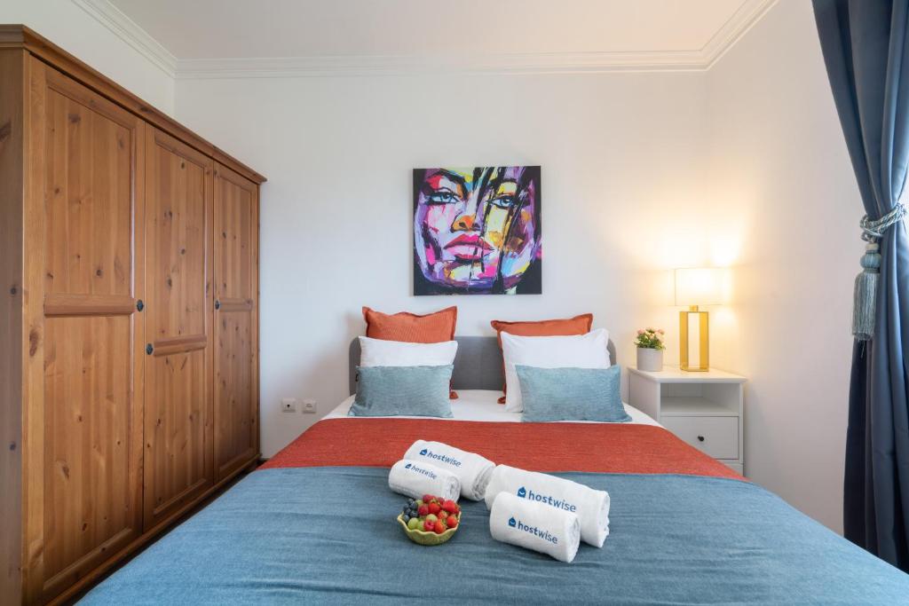 a bedroom with a bed with two towels on it at Sunny Cozy Flat w/ Terrace - São João in Porto