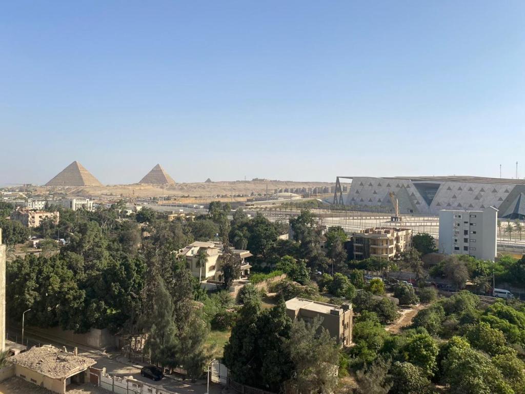 an aerial view of the pyramids of giza and the city at pyramids grand museum inn in Cairo