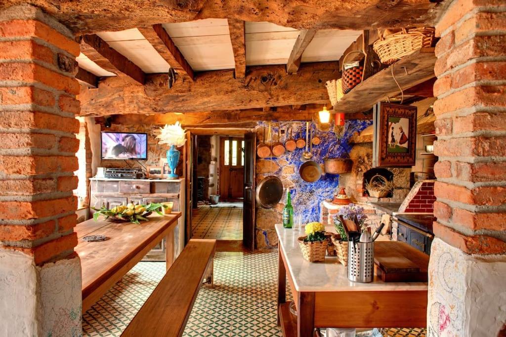 a kitchen with a table and a dining room at El nido de la golondrina in Llanes