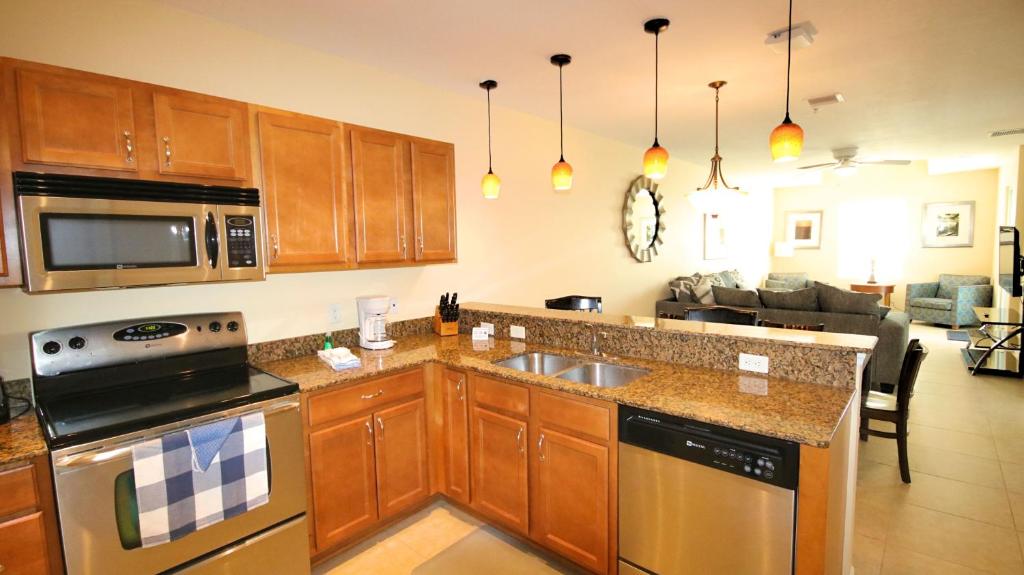 a kitchen with a sink and a stove top oven at Johns Pass Condo's- Fully Remote in St. Pete Beach
