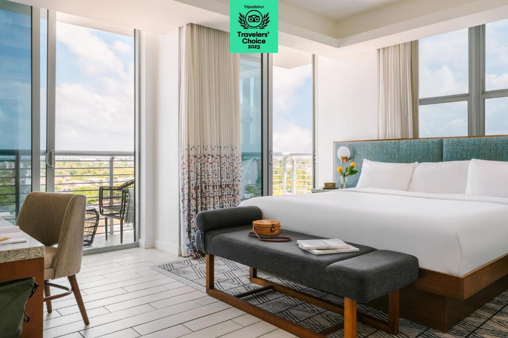 a hotel room with a bed and a balcony at The Circ powered by Sonder in Hollywood