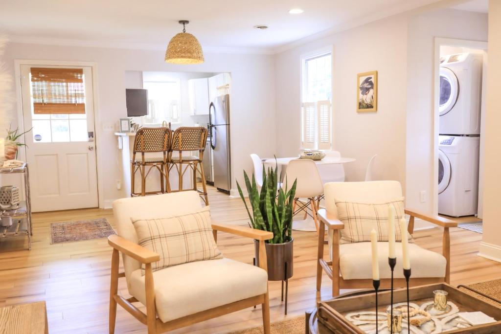 a living room with chairs and a dining room at Sleeps 10! Minutes to Parris Island & Downtown in Beaufort