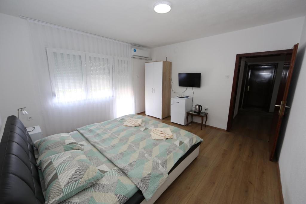 a bedroom with a bed and a television in it at Villa Rita in Ohrid