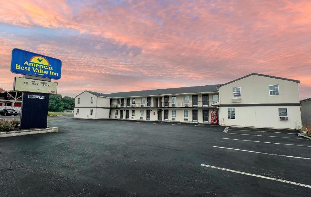 an empty parking lot in front of a hotel at America's Best Value Inn Lancaster in Lancaster