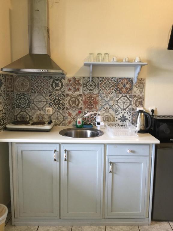 a kitchen with a sink and a counter top at happyWish Syros in Ermoupoli