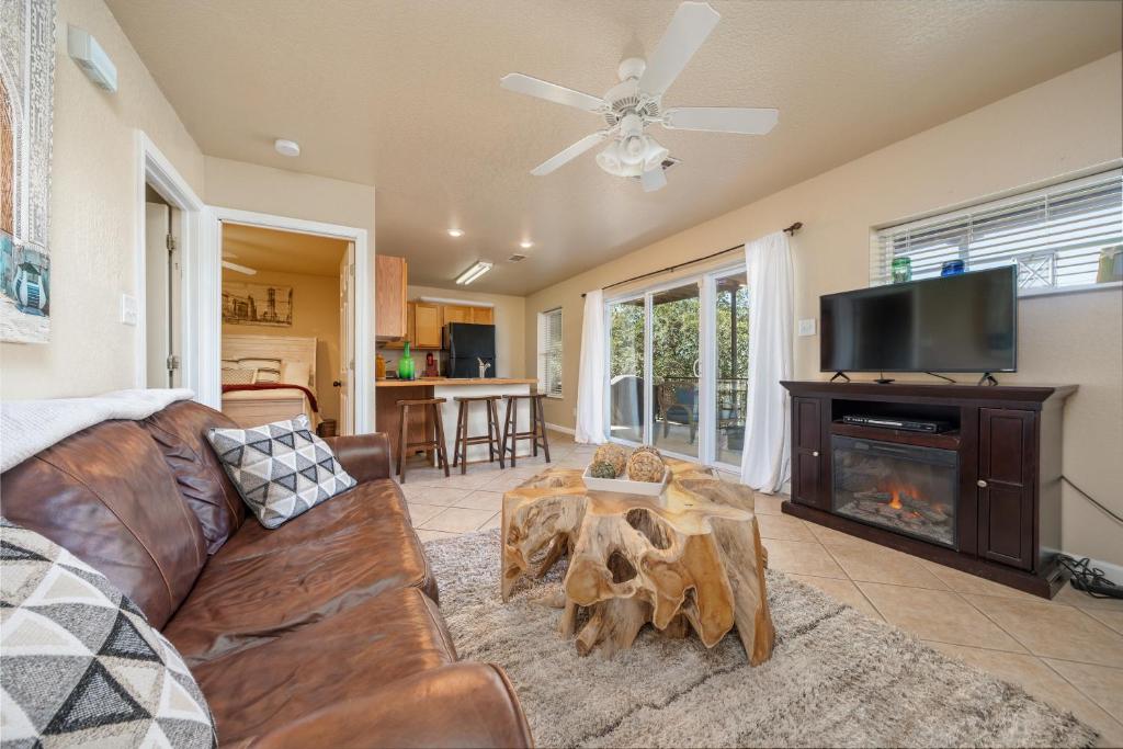 a living room with a couch and a fireplace at Ember’s View, Spa City Jewel- Lovely Lake Condo in Hot Springs