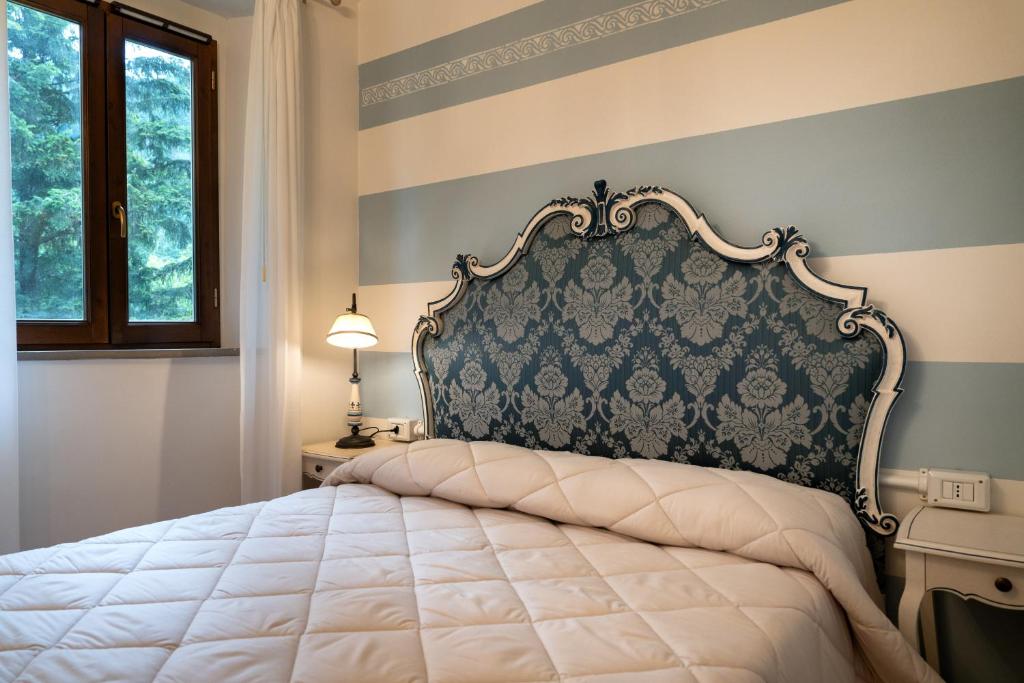 Postel nebo postele na pokoji v ubytování Hotel Rifugio la Foresta