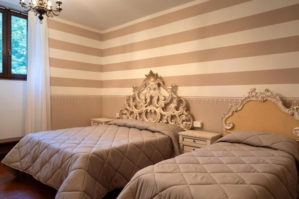 Postel nebo postele na pokoji v ubytování Hotel Rifugio la Foresta