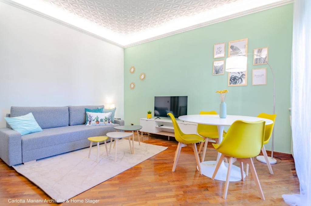 a living room with a couch and a table and chairs at La Casa di Azzurra in Rome