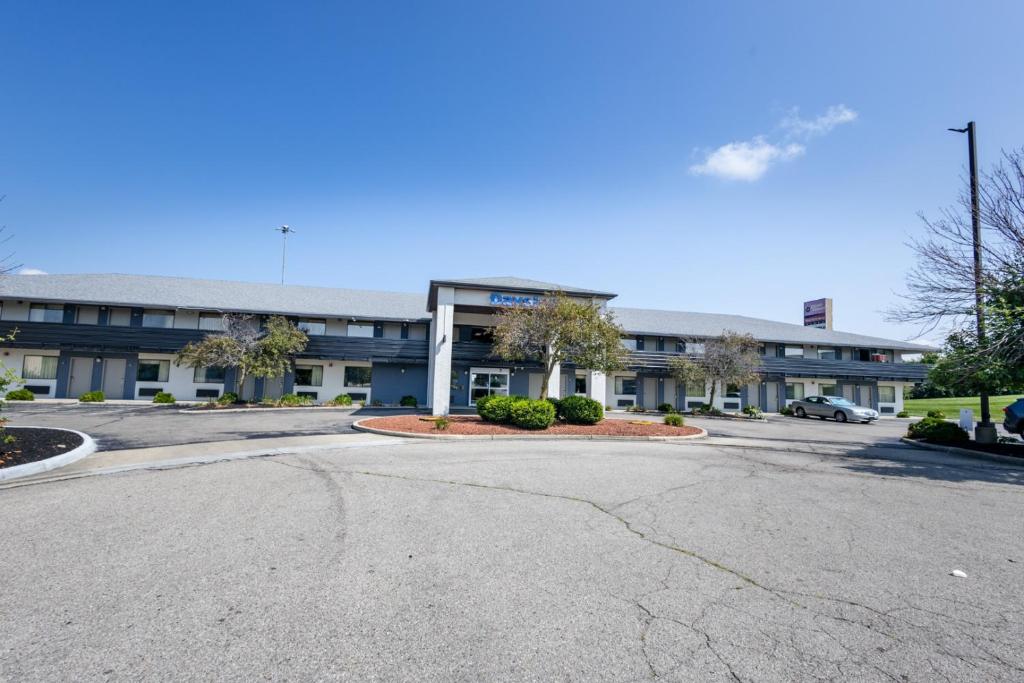 an empty parking lot in front of a building at Days Inn by Wyndham Dayton Huber Heights Northeast in Huber Heights