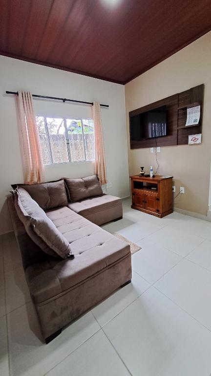 a living room with a couch and a window at Casa Acerola - Vila de São Jorge in Sao Jorge