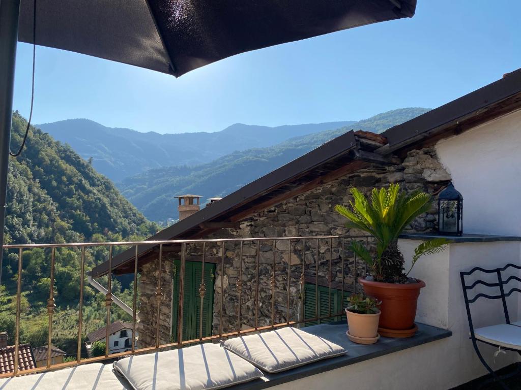 a balcony with a view of the mountains at Iconic Italian Townhouse w Rooftop Terrace & Mountain View, Pigna in Pigna