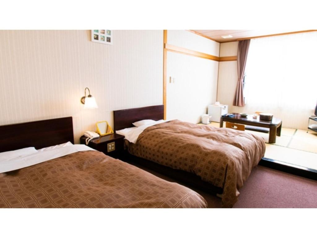 Postel nebo postele na pokoji v ubytování Ashinomaki Prince Hotel - Vacation STAY 55350v
