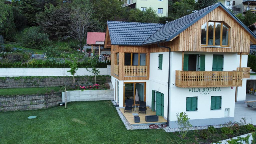 a house with a balcony and a wrap around deck at Villa Rodica, Bled in Bled