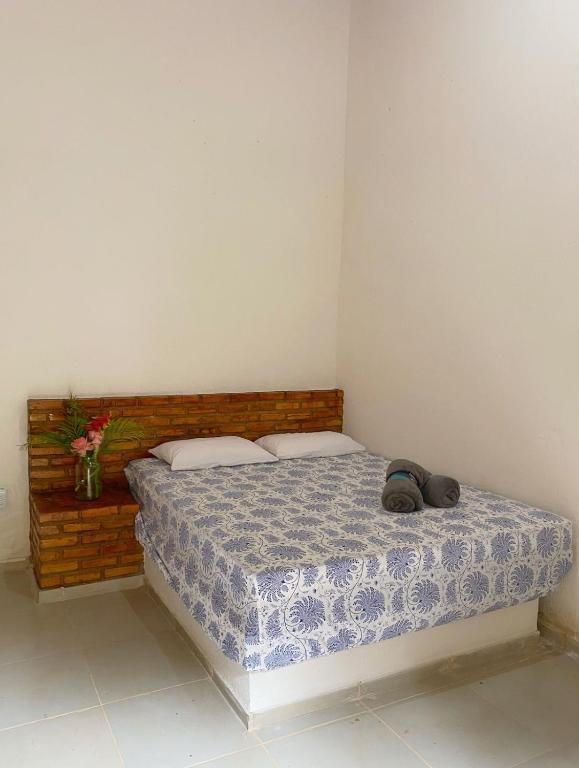 Un dormitorio con una cama con dos zapatos. en Chalé Duplo en Pacoti