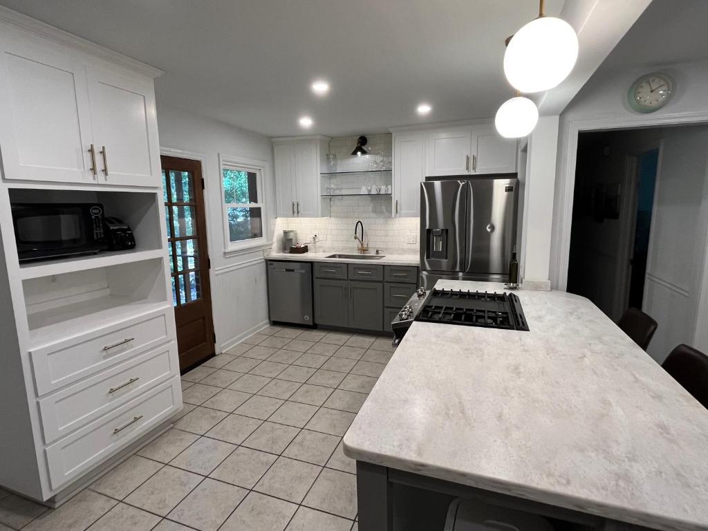 a kitchen with a refrigerator and a counter top at Modern Athens Home 4bd, 3bth in Athens